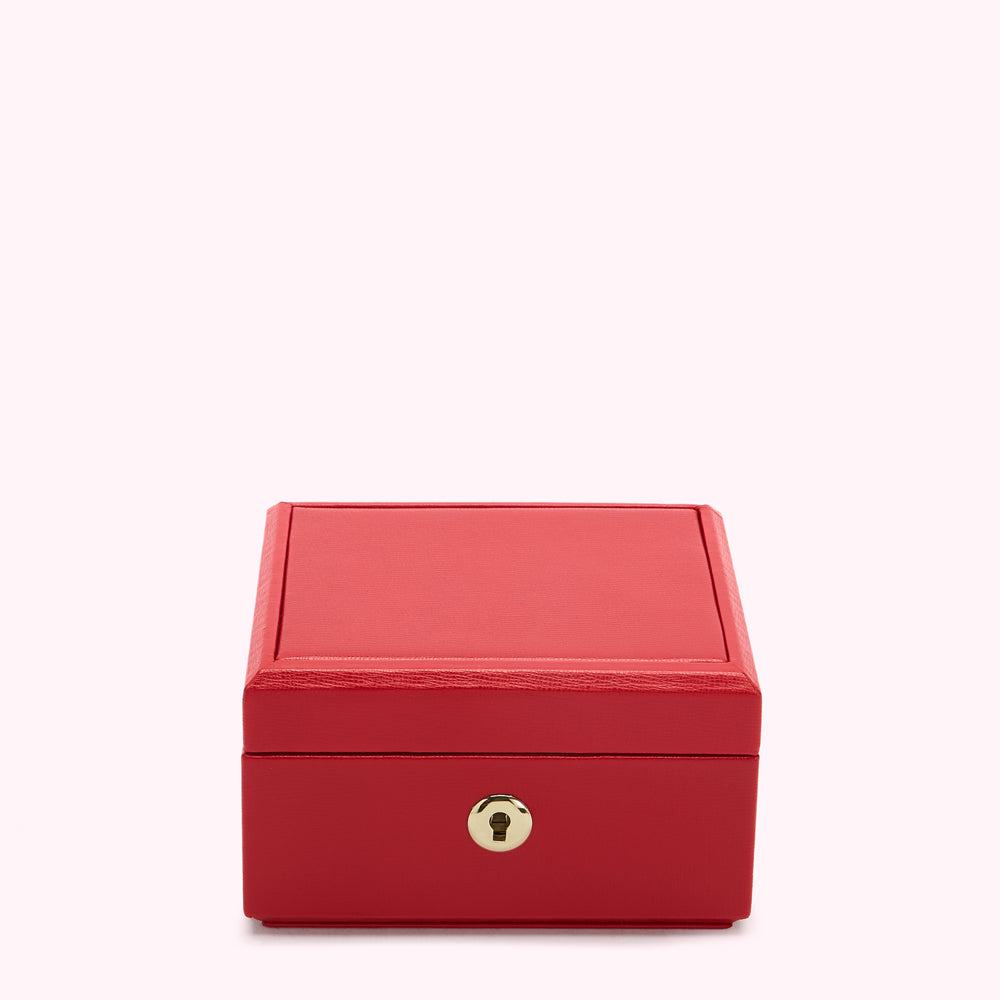 A red leather-bound box with a gold lock.
