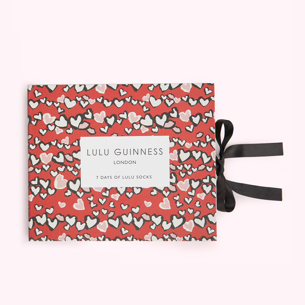 Red box with black ribbon, 7 pairs of Lulu Guinness socks, hearts pattern.

