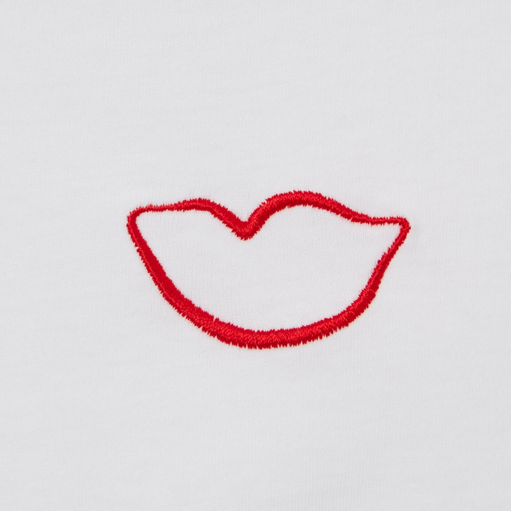 Red lips embroidered on a white background.
