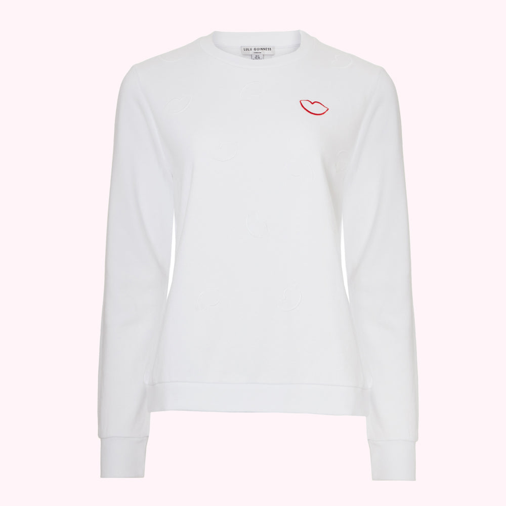 White Lulu Guinness sweatshirt with embossed lips and a single red embroidered lip.
