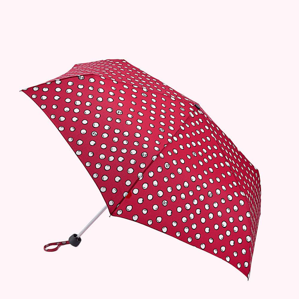 Red polka dot umbrella, open, on white background.
